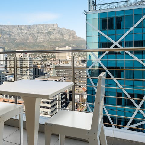 Admire the mountain and city views from the private balcony