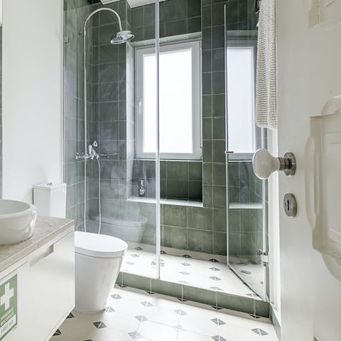 Relax under the green-tiled rainfall shower after a day of sightseeing