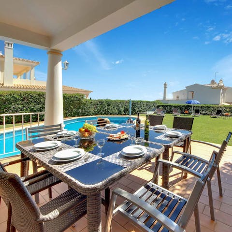 Dine alfresco on the covered terrace beside the pool
