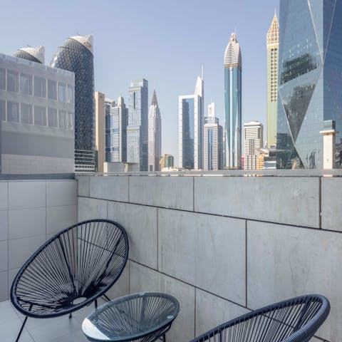 Take in the eclectic architectural styles of the city's skyscrapers from the private balcony
