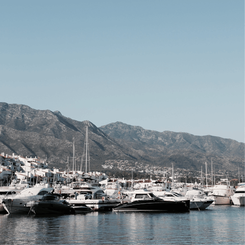 Stroll along the marina boardwalk after dinner in the nearby town of Marbella 