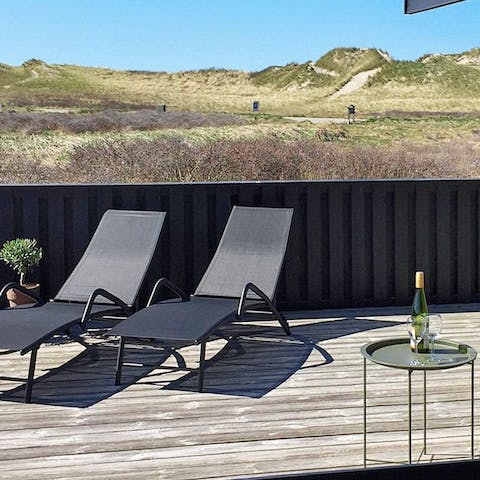 Stretch out on the lounge chairs with a glass of wine and soak up the summer sunshine