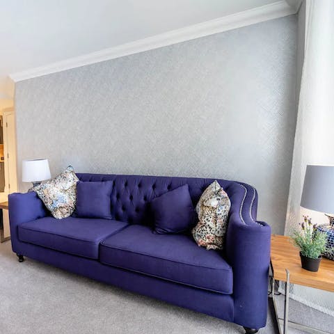 Get comfortable with a cup of Earl Grey on the plush, purple sofa