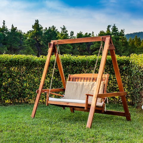 Relax with your favourite book on the two-seater swing chair