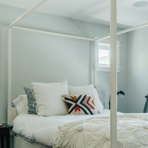 Get some rest in the master bedroom's four poster bed