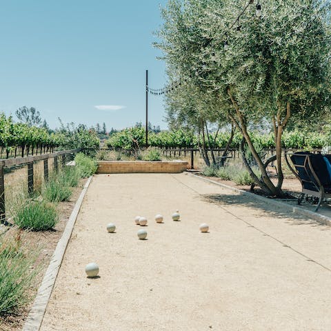 Enjoy a friendly game of bocce ball on the court next to the vines