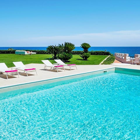 Soak up the sun by the private pool with a stunning sea view