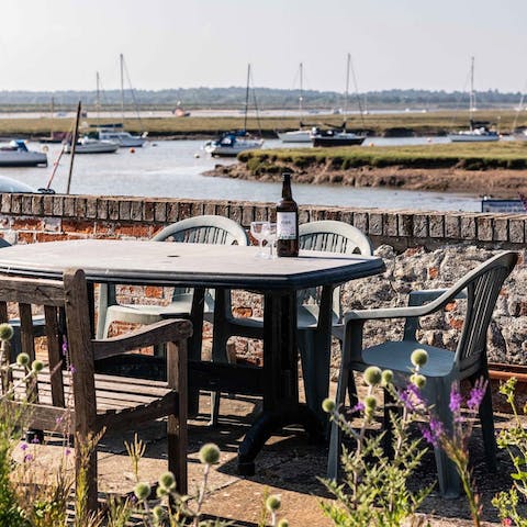 Sip a sundowner on the raised outdoor seating area while watching the boats go by