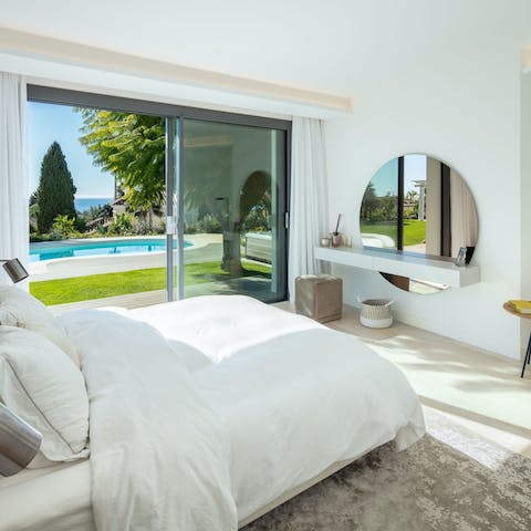 Wake up with direct access out onto the pool and garden from your stylish bedroom