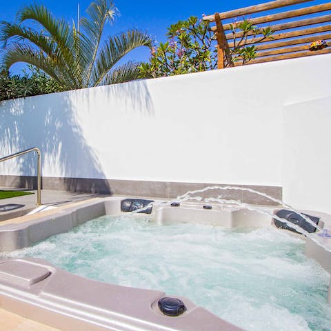 Unwind in the pool's sunken hot tub