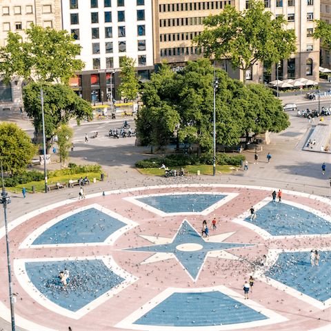 Explore one of the city's main meeting points, Plaça Catalunya, a twelve-minute stroll away