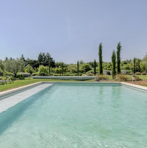 Swim beneath the cypress trees in the private pool