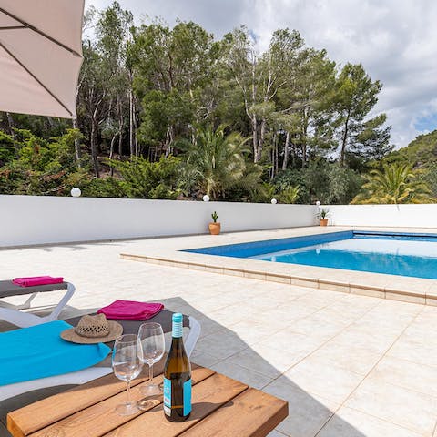 Rest on a lounger with a glass of wine or enjoy a cooling swim in the outdoor pool