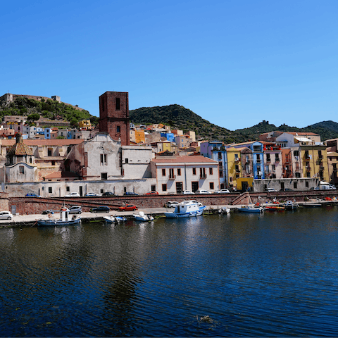 Head to Bosa and admire the pastel houses and hilltop castle 