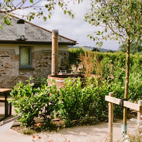 Relax and unwind outdoors in the wood-fired hot tub