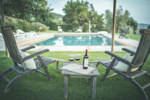 Sit by the pool with a glass of local wine before enjoying a lovely dip in the water
