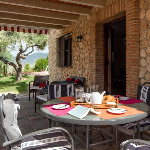 Gather together for a shaded alfresco meal on the front patio