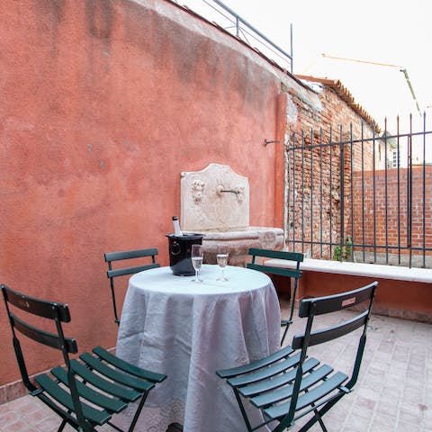Take your evening tipple on the private patio tucked away