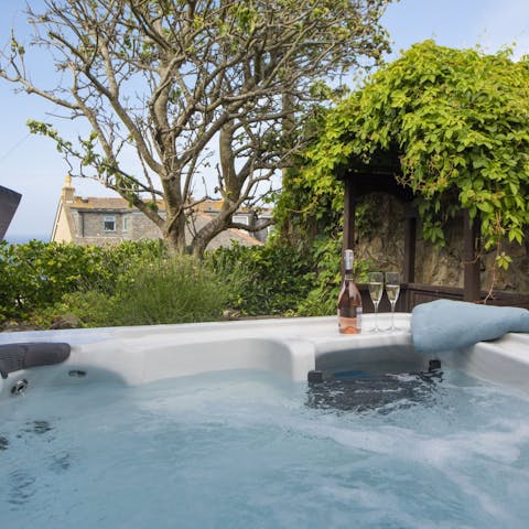 Enjoy a glass of something bubbly while relaxing in the hot tub