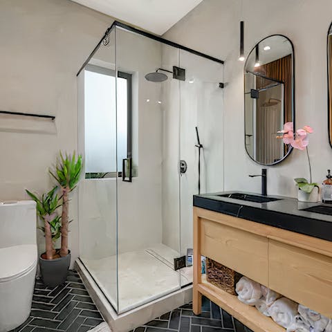 Relax stiff muscles under the rainfall shower in the spa-style bathroom