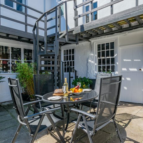 Enjoy a glass of wine outside in the sunny courtyard