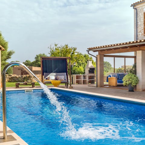 Take a relaxing dip in the private pool, complete with water features
