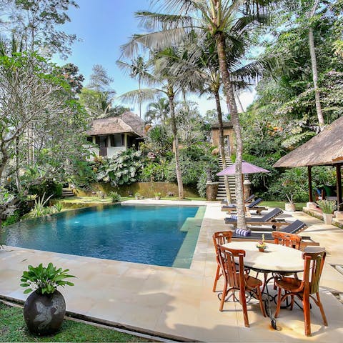 Drink, dine or lounge beside your private, outdoor pool surrounded by lush greenery