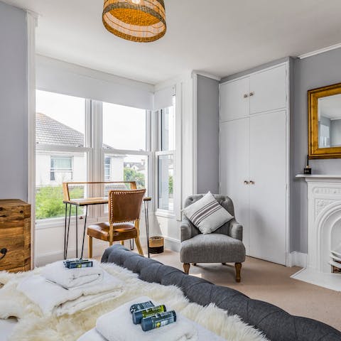 Open your laptop at the little bedroom desk, tucked in a bright bay window