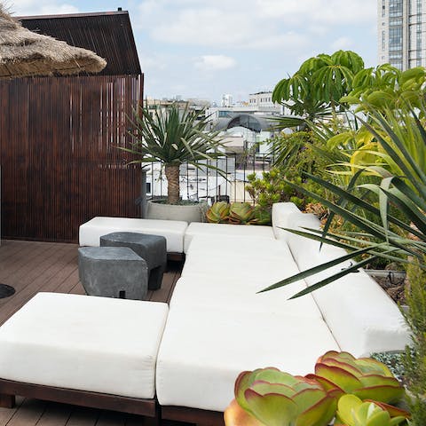 Relax among exotic foliage on the wooden terrace with a cup of coffee