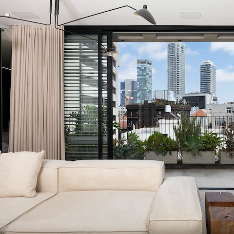 Enjoy extraordinary city views from the glass sliding doors in your lounge