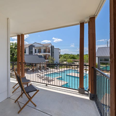 Relax with a view of the pool on the private balcony 