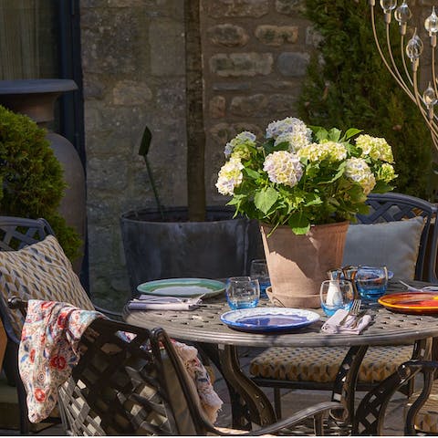 Enjoy a glass of wine in the private courtyard with its verdant shrubs