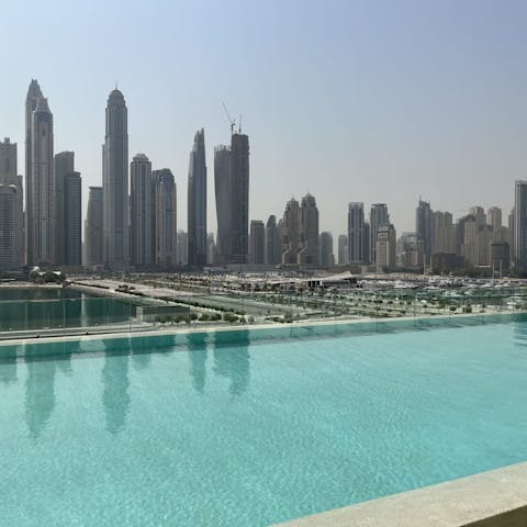 Swim in the communal pool as skyscrapers tower around you