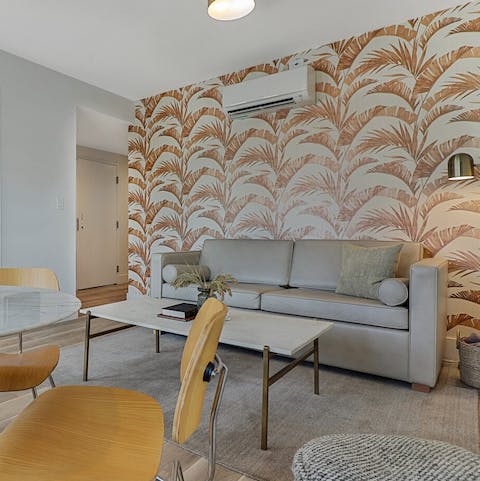 Curl up on the couch beneath the palm print wallpaper after a day at the beach