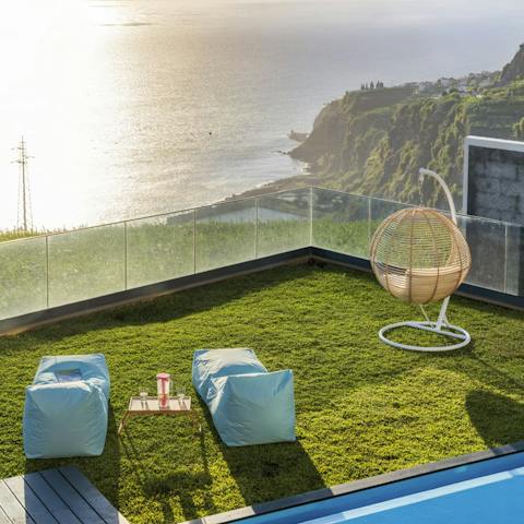 Relax on the lush green lawn and admire the rippling ocean