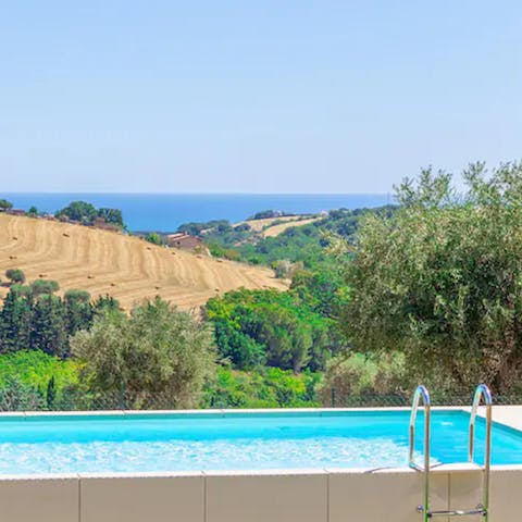 Gaze out at the rolling hills of the Marche countryside as you unwind in the outdoor pool