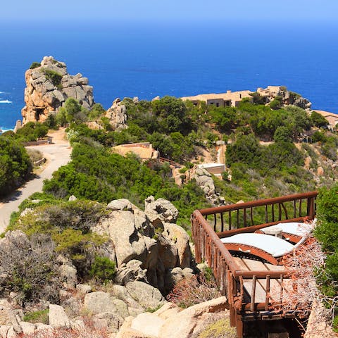 Relax on the sun loungers while luxuriating in the stunning Sardinian scenery
