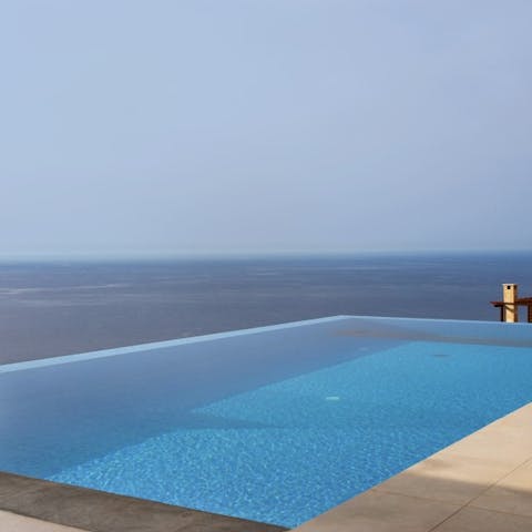 Swim in the infinity pool looking out over the sea