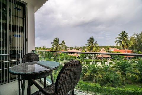 Enjoy breakfast with stunning views over the palm trees from your private balcony
