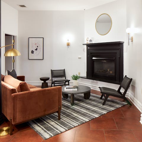 Put your feet up by the fire in the shared lounge, after a long day of exploring the city
