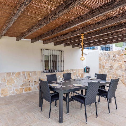 Dine shaded by the rustic wooden ceiling