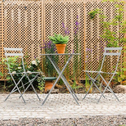 Sip tea at the outdoor table for two, great for good weather