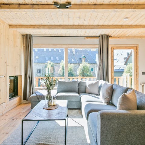 Snuggle up in front of the fire in the living room for a catch up with loved ones, one of two living areas in this home