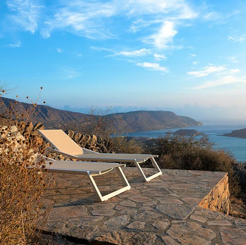 Soak up the sun on the loungers, sitting in an elevated spot overlooking the sea