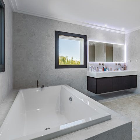 Treat yourself to a luxurious bath in one of the sleek bathrooms 