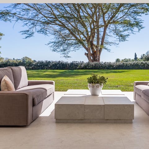 Relax on one of the outside sofas and enjoy the tranquillity of the huge garden 