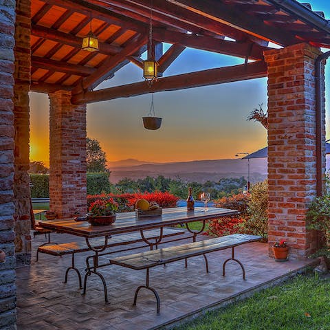 Sit down to an alfresco meal while watching the sun set behind the hills