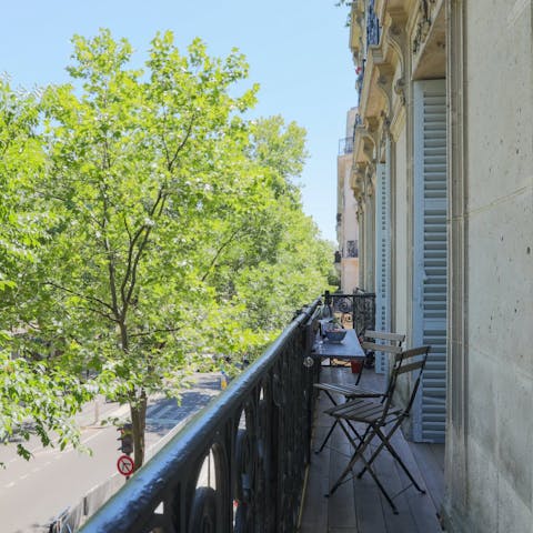 Savour a glass of wine on the balcony overlooking Boulevard de Magenta