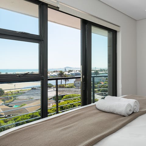 Wake up to gorgeous coastal views from the bedroom's floor-to-ceiling window