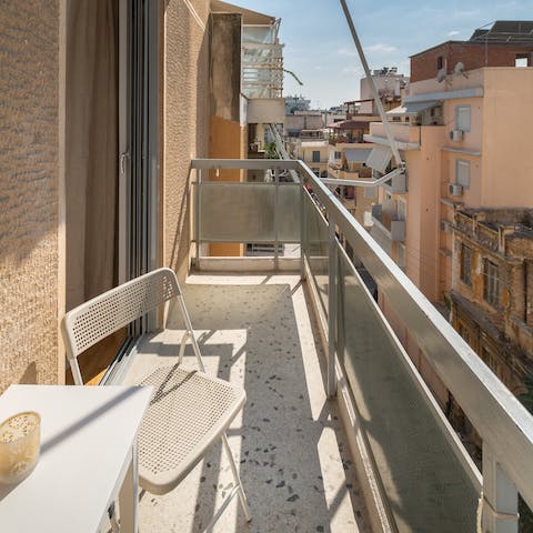 Enjoy a cup of coffee or a glass of Grecian wine on the private balcony 